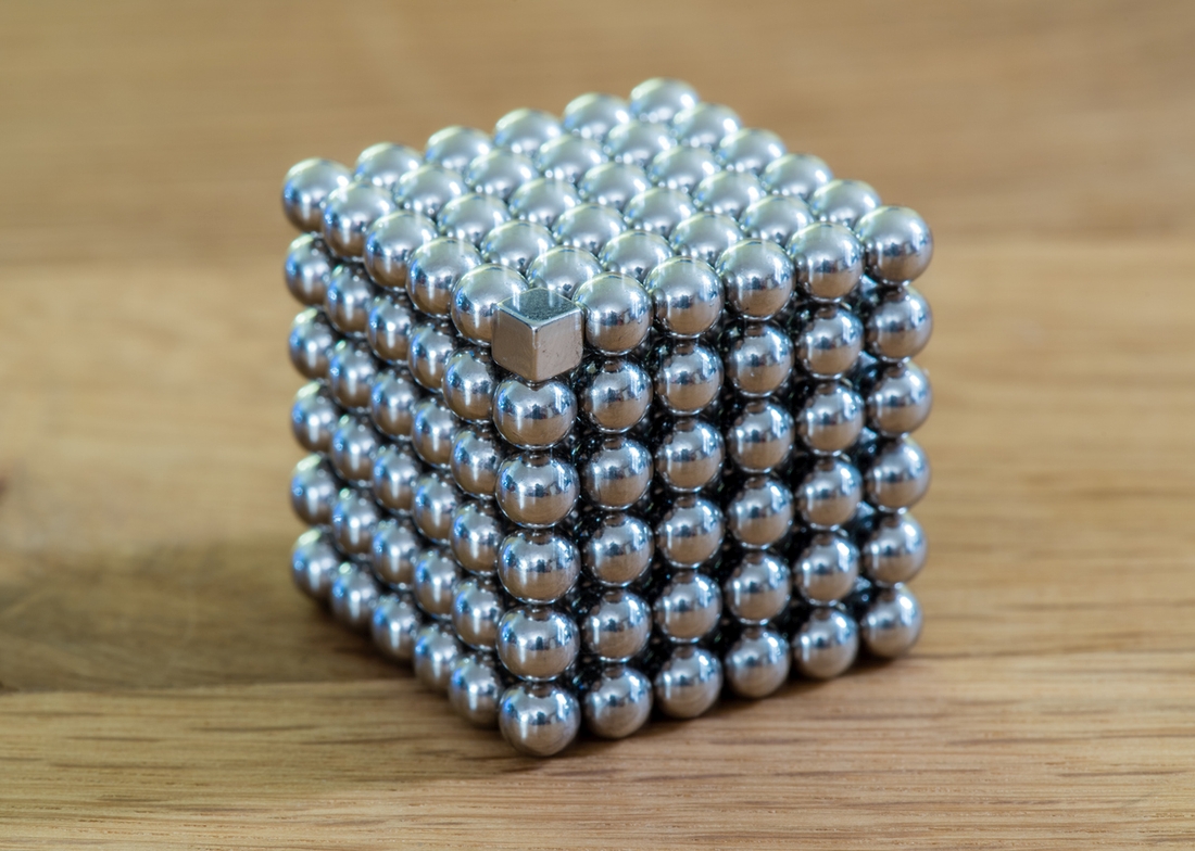 metal ball in a cube of square magnets thinking out of the box