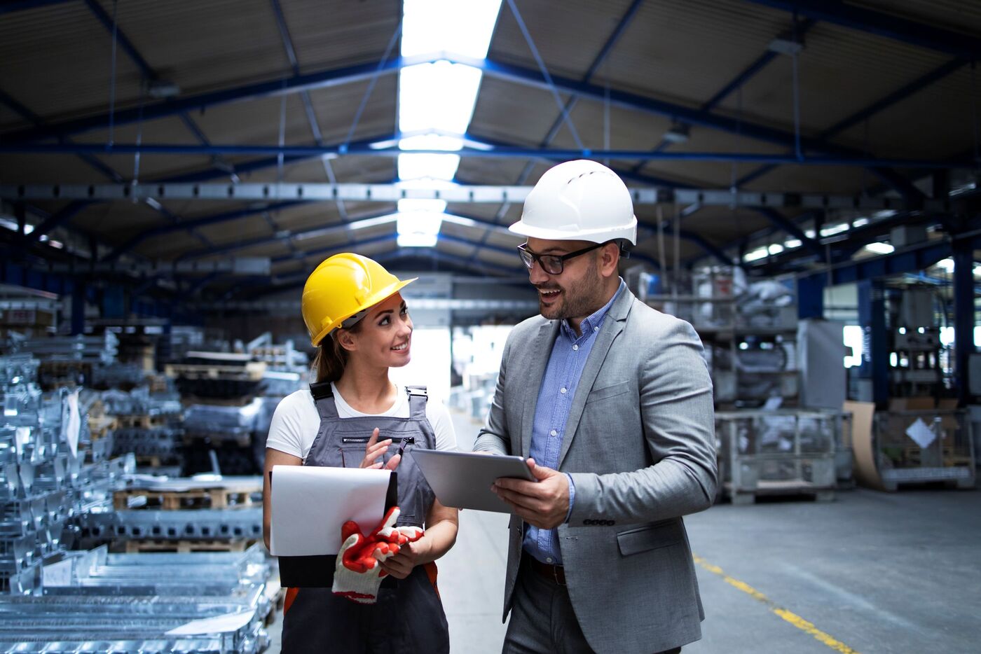 manager supervisor worker discussing about production results new strategy factory industrial hall